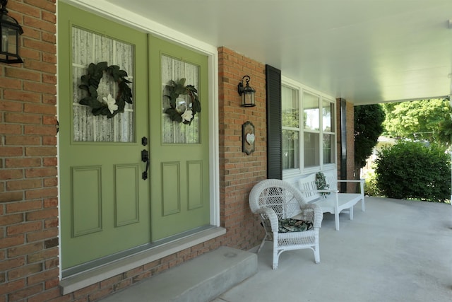 view of exterior entry with a porch