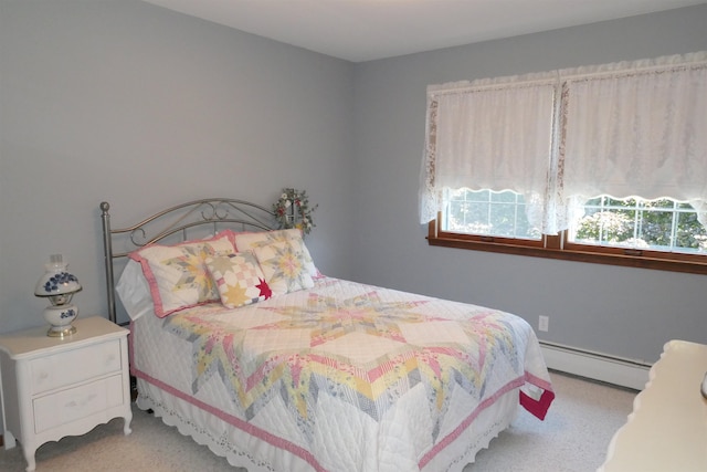 bedroom with light colored carpet and baseboard heating