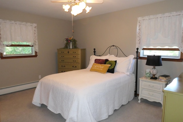 carpeted bedroom featuring baseboard heating and ceiling fan