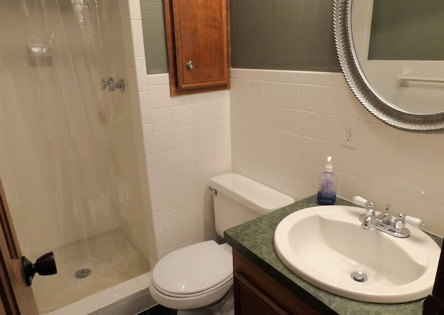 bathroom featuring curtained shower, vanity, tile walls, and toilet