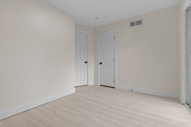 spare room featuring light wood-type flooring