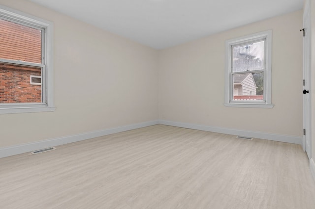 spare room with light hardwood / wood-style flooring