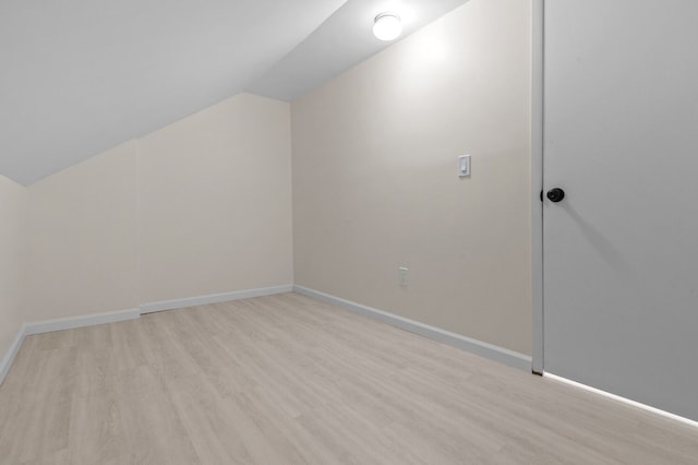 bonus room featuring light hardwood / wood-style floors and lofted ceiling