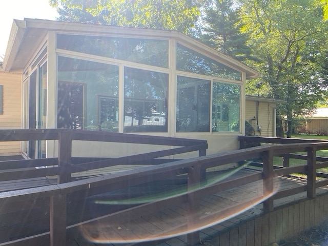 view of home's exterior featuring a deck and a sunroom