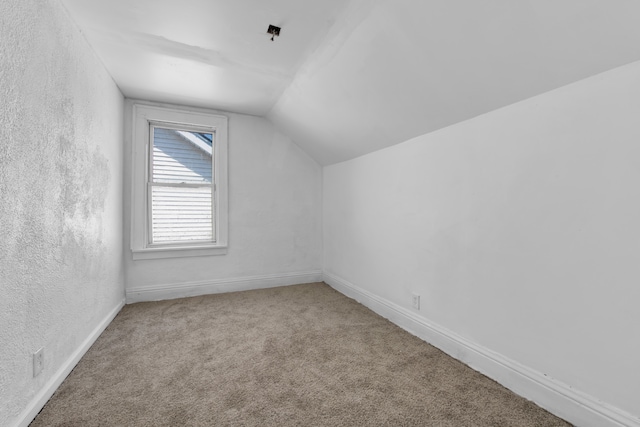 bonus room with carpet floors and lofted ceiling