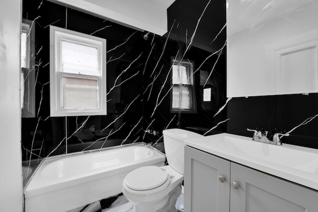 full bathroom featuring  shower combination, vanity, tile walls, and toilet