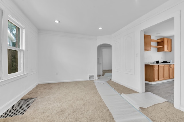 carpeted empty room with crown molding