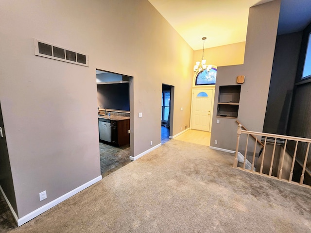 interior space featuring an inviting chandelier, high vaulted ceiling, and sink