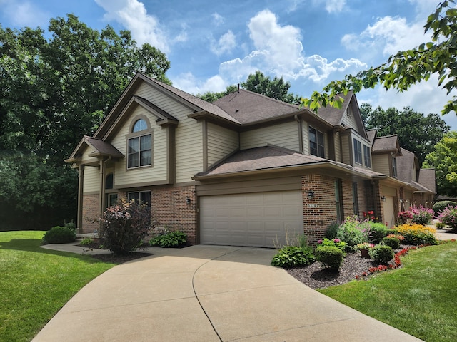 view of front of property featuring a front lawn and a garage