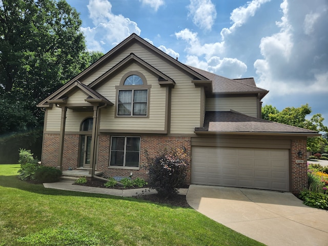 view of front of property with a front yard and a garage