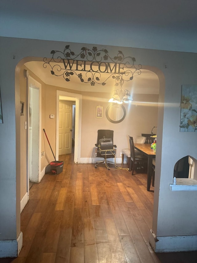 interior space featuring a chandelier and wood-type flooring