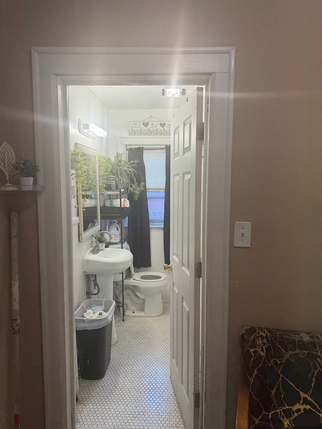 bathroom featuring tile patterned floors and toilet