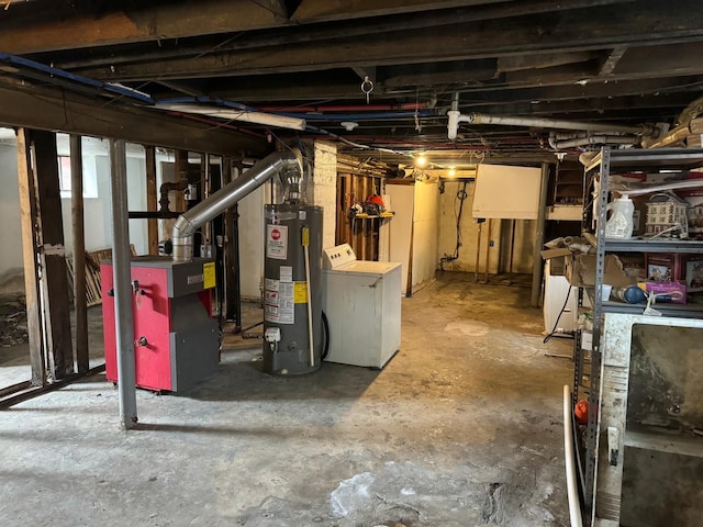 basement featuring water heater and washer / dryer