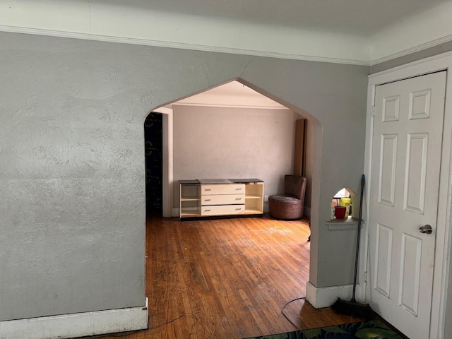 interior space featuring hardwood / wood-style flooring and crown molding