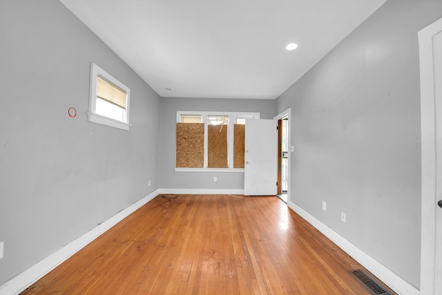 unfurnished room with hardwood / wood-style floors