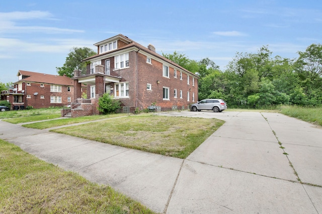 view of side of property with a yard