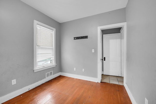 spare room with hardwood / wood-style floors