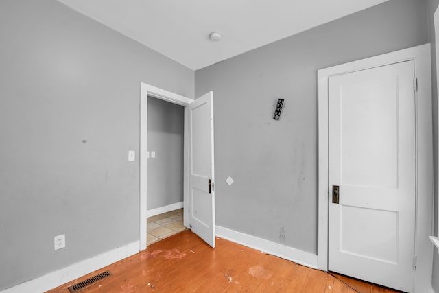 unfurnished bedroom featuring light wood-type flooring