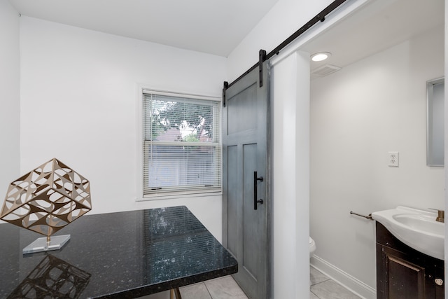 bathroom featuring tile patterned floors, vanity, and toilet