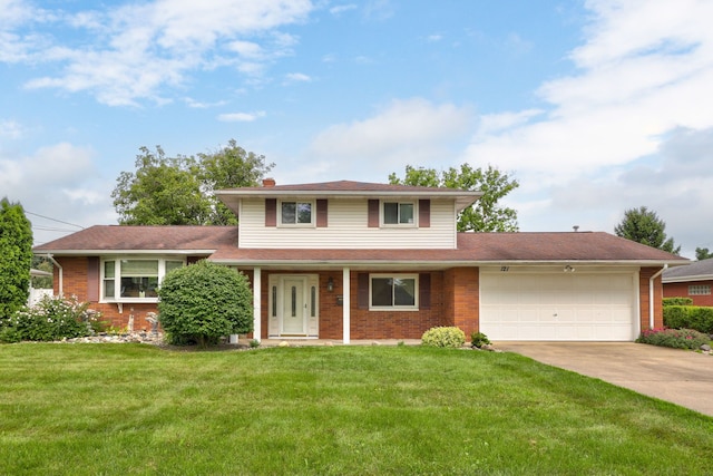 view of front facade featuring a front lawn, brick siding, concrete driveway, and an attached garage