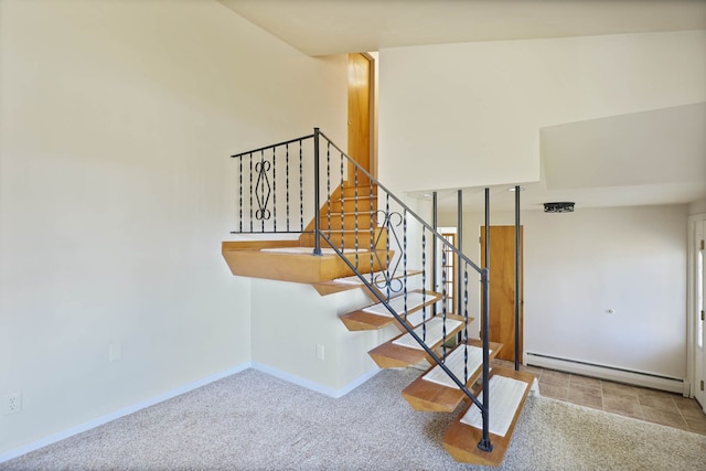 stairs with baseboards, a baseboard heating unit, and carpet