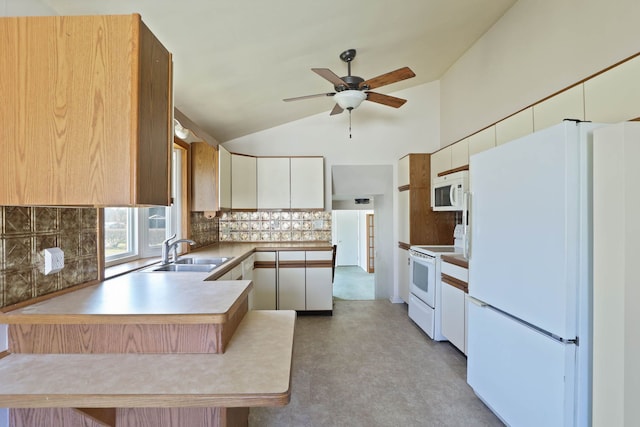 kitchen with a ceiling fan, a sink, white appliances, a peninsula, and decorative backsplash