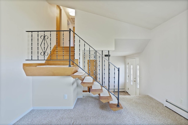 stairway featuring baseboard heating, carpet, and baseboards