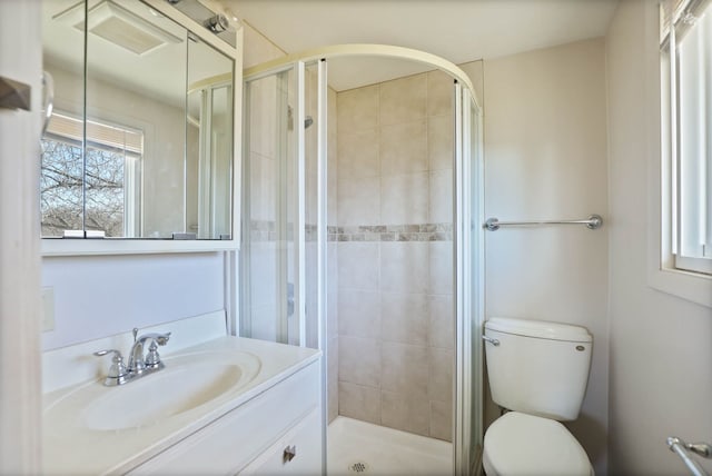 full bath featuring vanity, a shower stall, and toilet