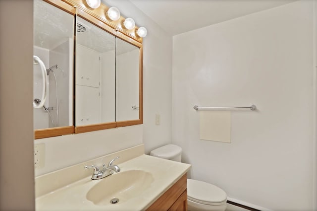 bathroom featuring toilet and vanity