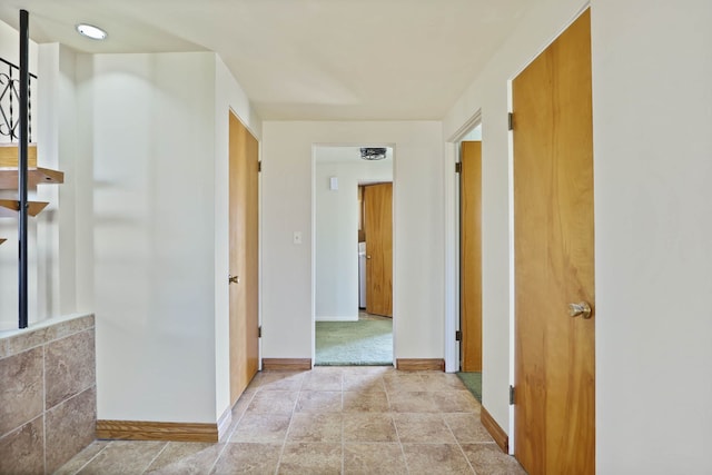 hallway featuring baseboards