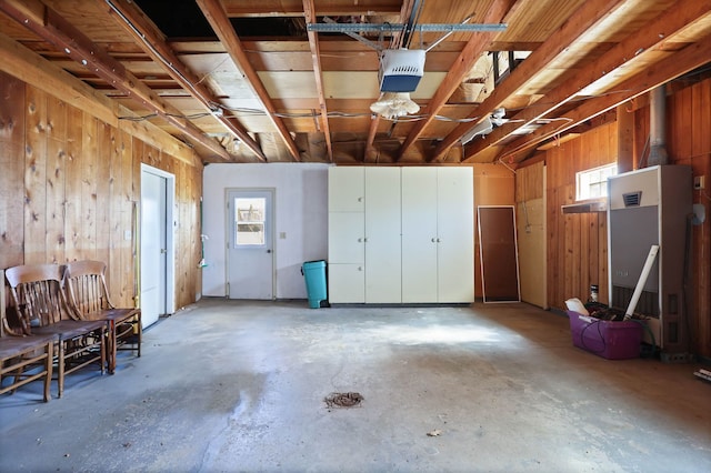 garage featuring wooden walls and a garage door opener