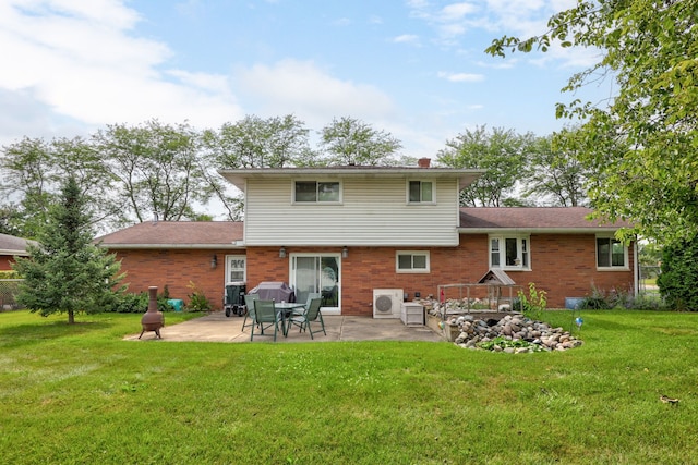 rear view of house featuring brick siding, a patio area, a chimney, and a lawn