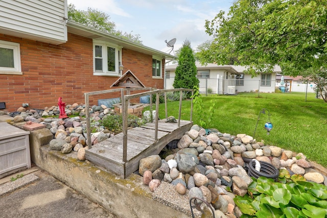 view of yard with fence and central AC