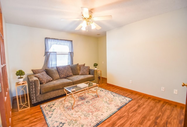 living room with hardwood / wood-style flooring and ceiling fan