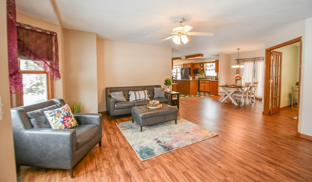 204 W Hatmaker Rd, Coldwater, MI 49036 - living area with wood finished floors, ceiling fan, and a chandelier