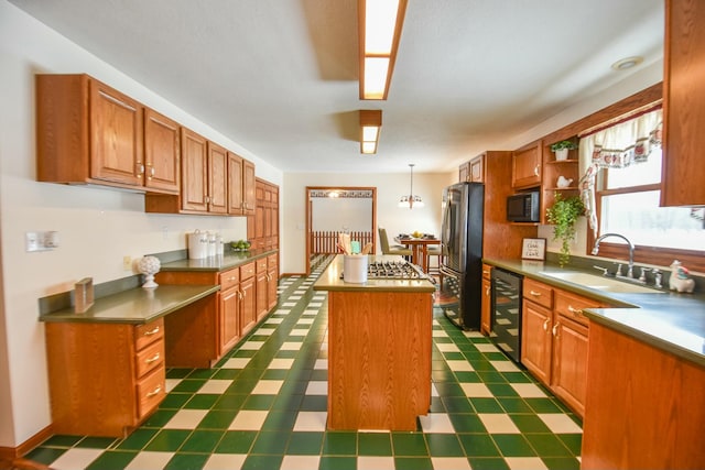 204 W Hatmaker Rd, Coldwater, MI 49036 - kitchen with black appliances, a center island, dark flooring, pendant lighting, and brown cabinets