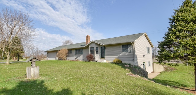 204 W Hatmaker Rd, Coldwater, MI 49036 - view of front of home with a chimney, an attached garage, and a front yard