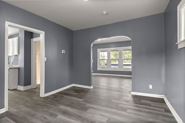 spare room with dark hardwood / wood-style flooring