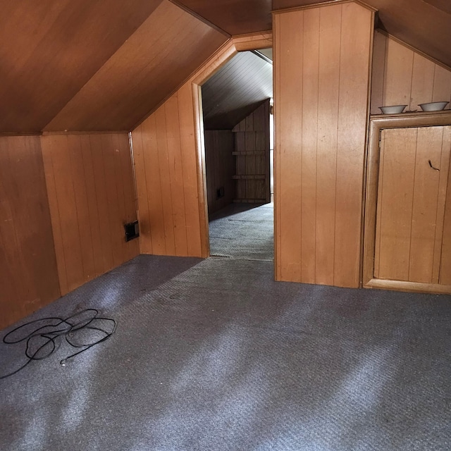 bonus room with carpet flooring, lofted ceiling, wooden walls, and wood ceiling