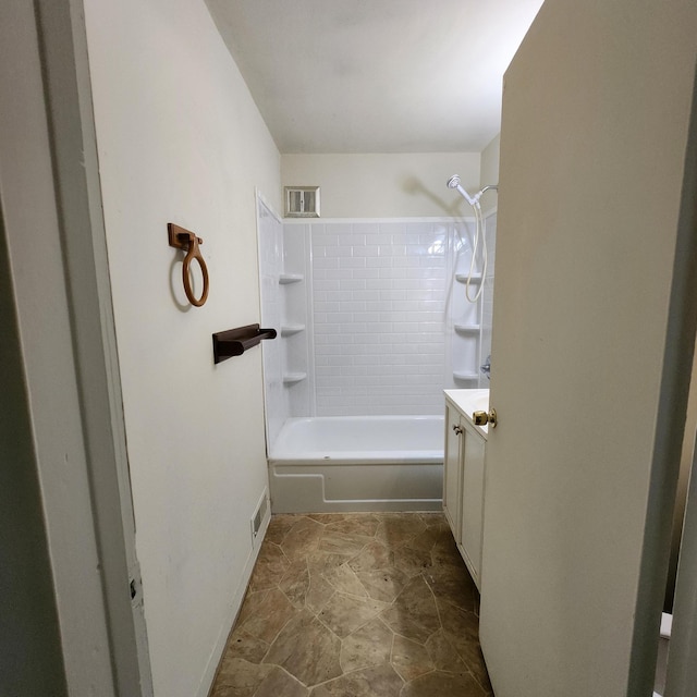 bathroom with vanity and tiled shower / bath