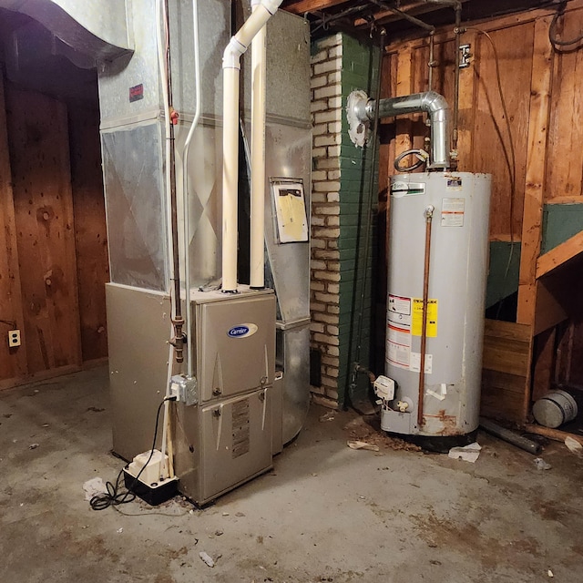 utility room with heating unit and water heater