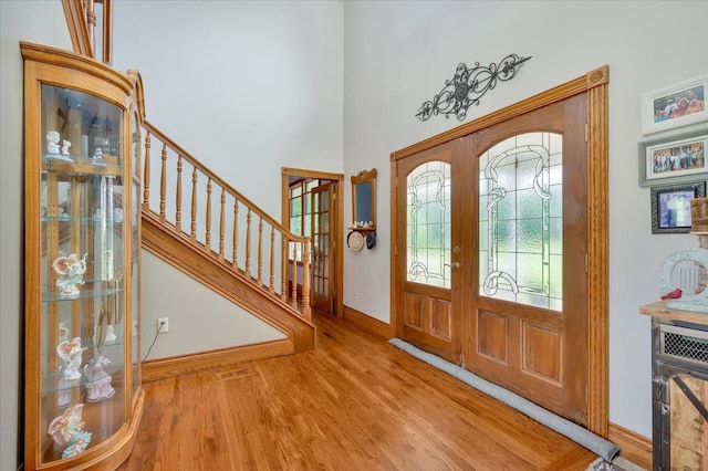 foyer entrance featuring french doors and light wood-type flooring