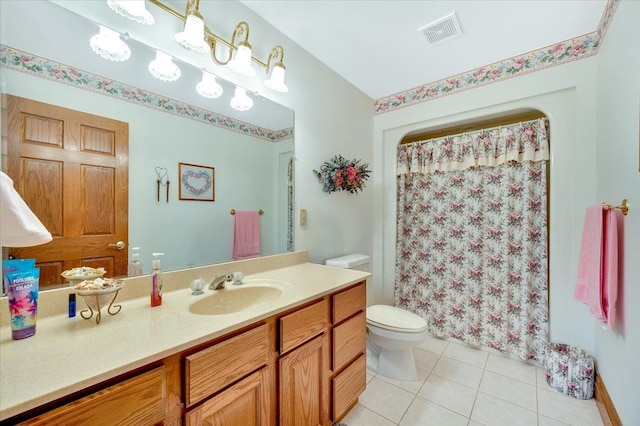 bathroom featuring tile patterned flooring, vanity, and toilet