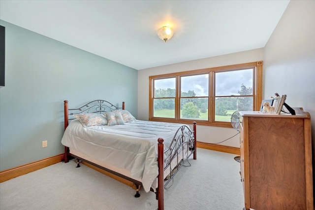 carpeted bedroom featuring lofted ceiling