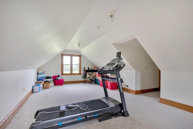 workout room with light carpet and lofted ceiling