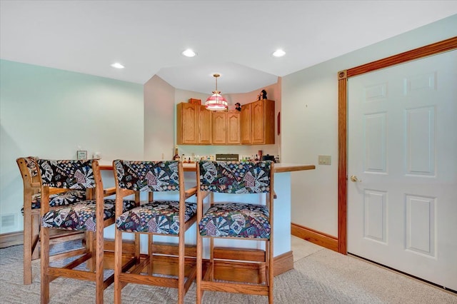 dining room with light colored carpet