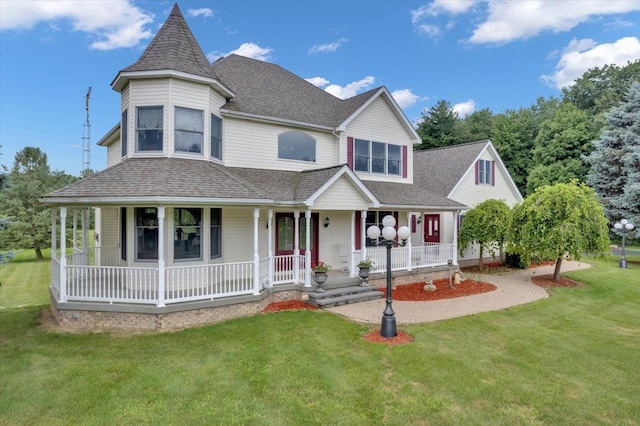 view of front of house featuring covered porch and a front yard