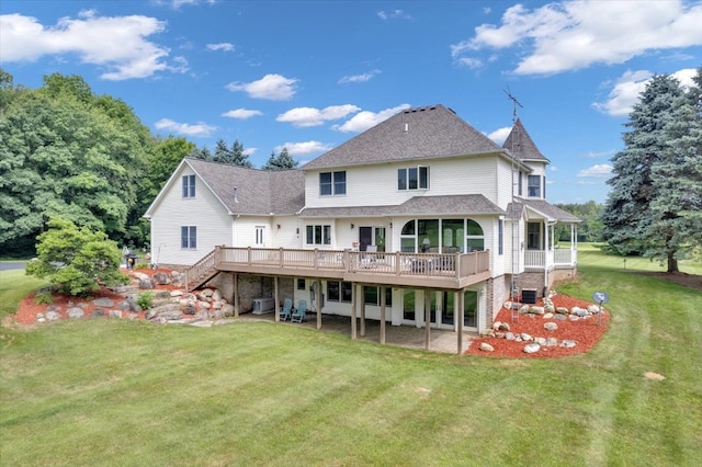 back of house featuring a lawn, central AC unit, and a deck