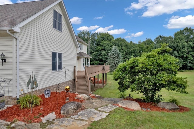 exterior space with a yard and a wooden deck