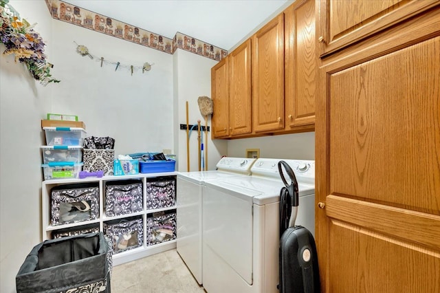 laundry area with washer and dryer and cabinets